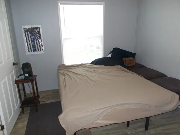 a bed sitting in a bedroom next to a window