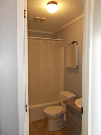 a bathroom with a toilet and a shower