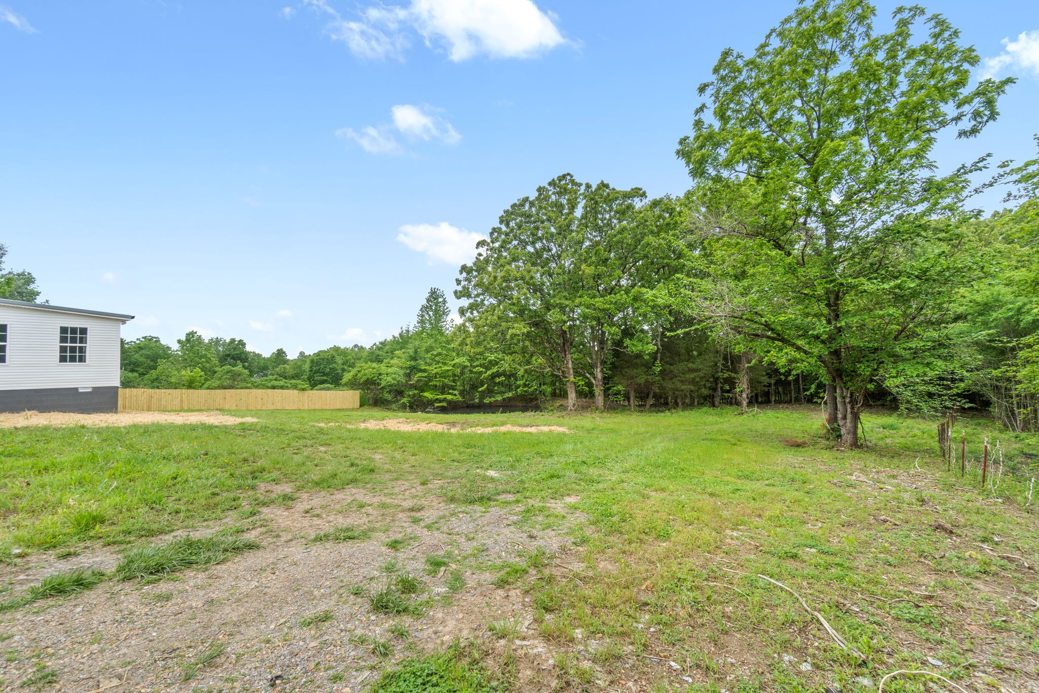 4366 Old Metal Road Palmyra, TN 37142 - Photo 37 of 43 a view of a grassy field with trees in the background