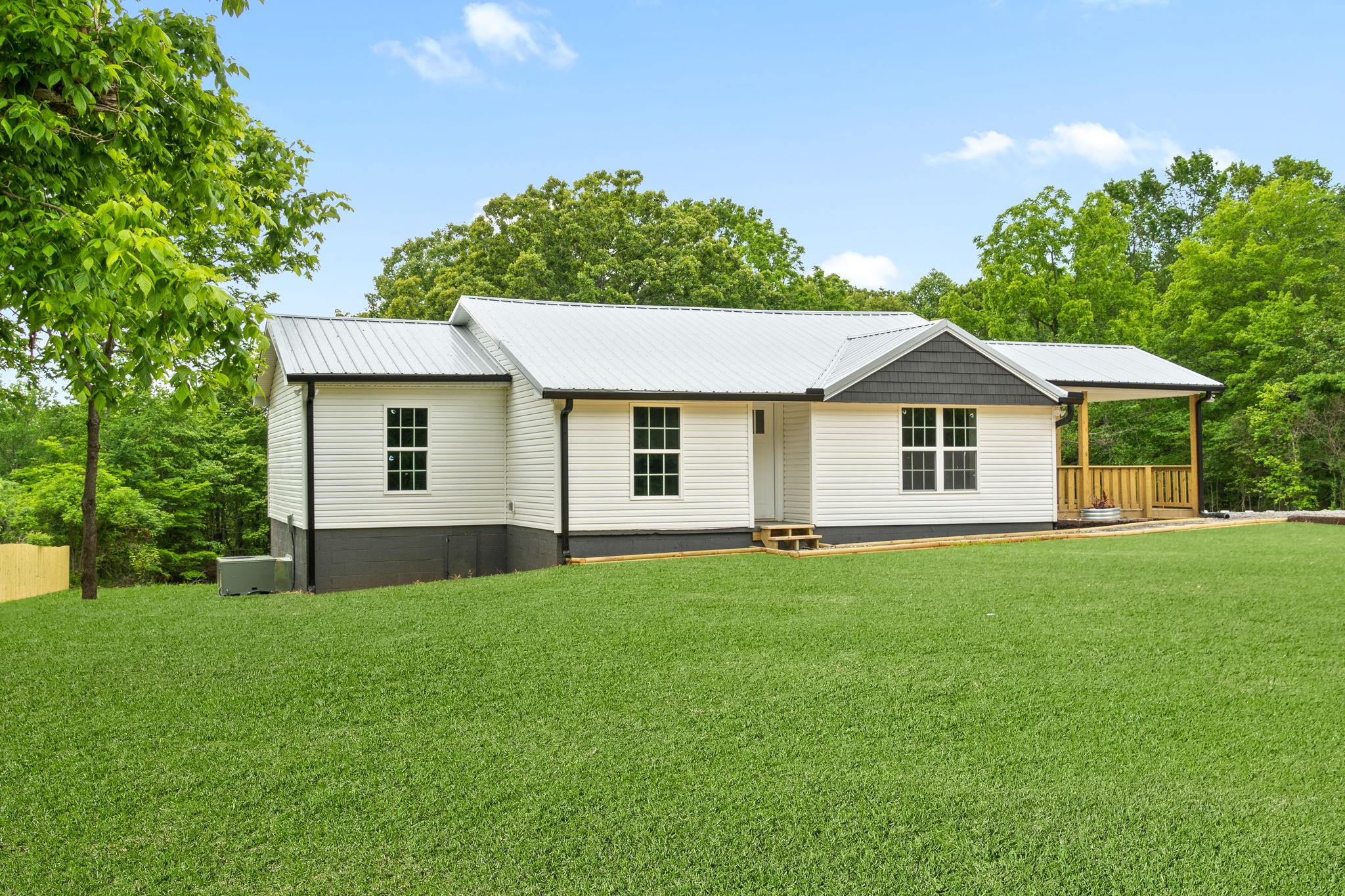 4366 Old Metal Road Palmyra, TN 37142 - Photo 5 of 43 a front view of a house with a garden