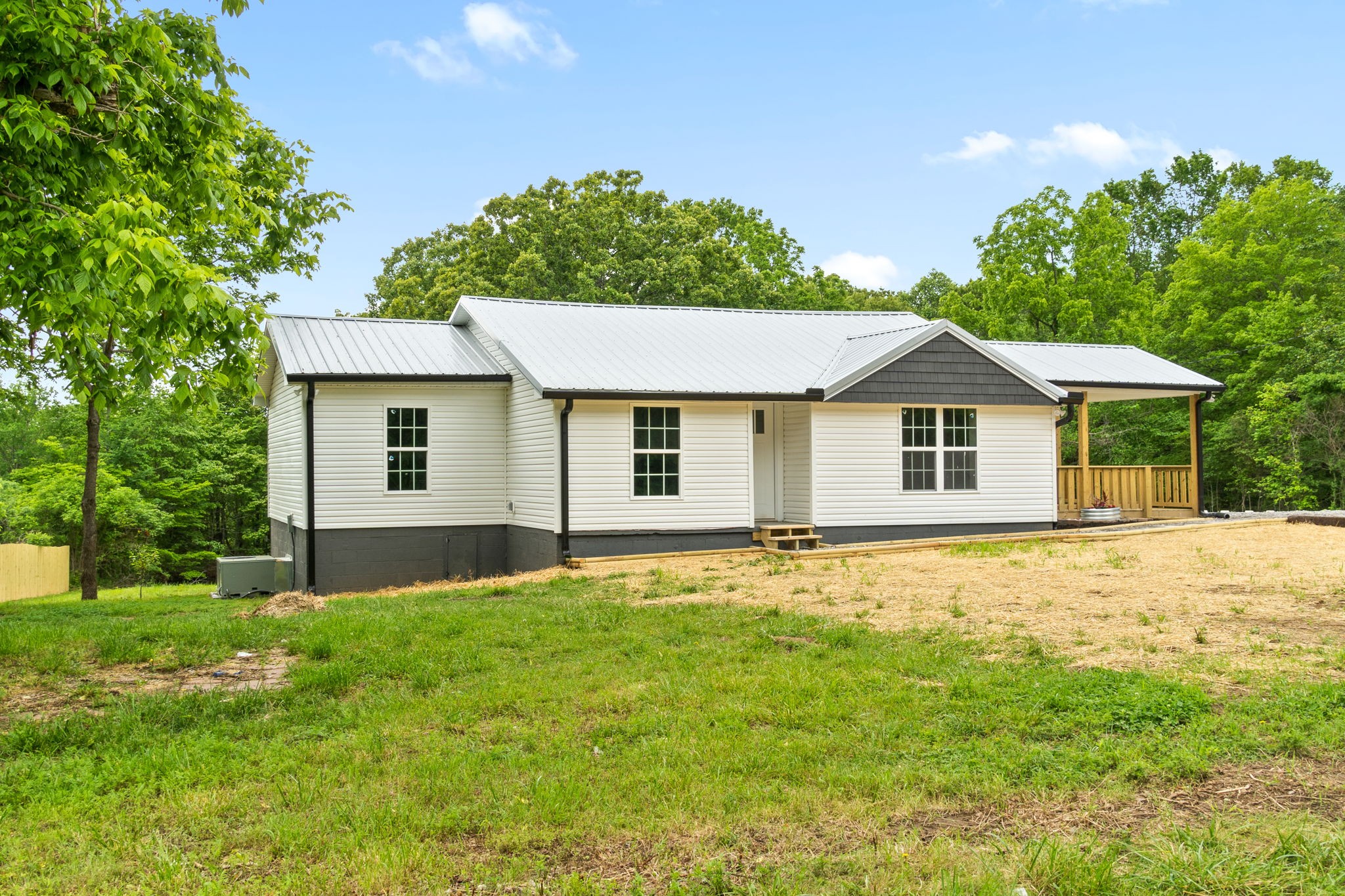 4366 Old Metal Road Palmyra, TN 37142 - Photo 6 of 43 a front view of a house with a garden