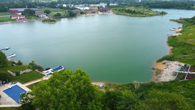 an aerial view of a house with a lake view