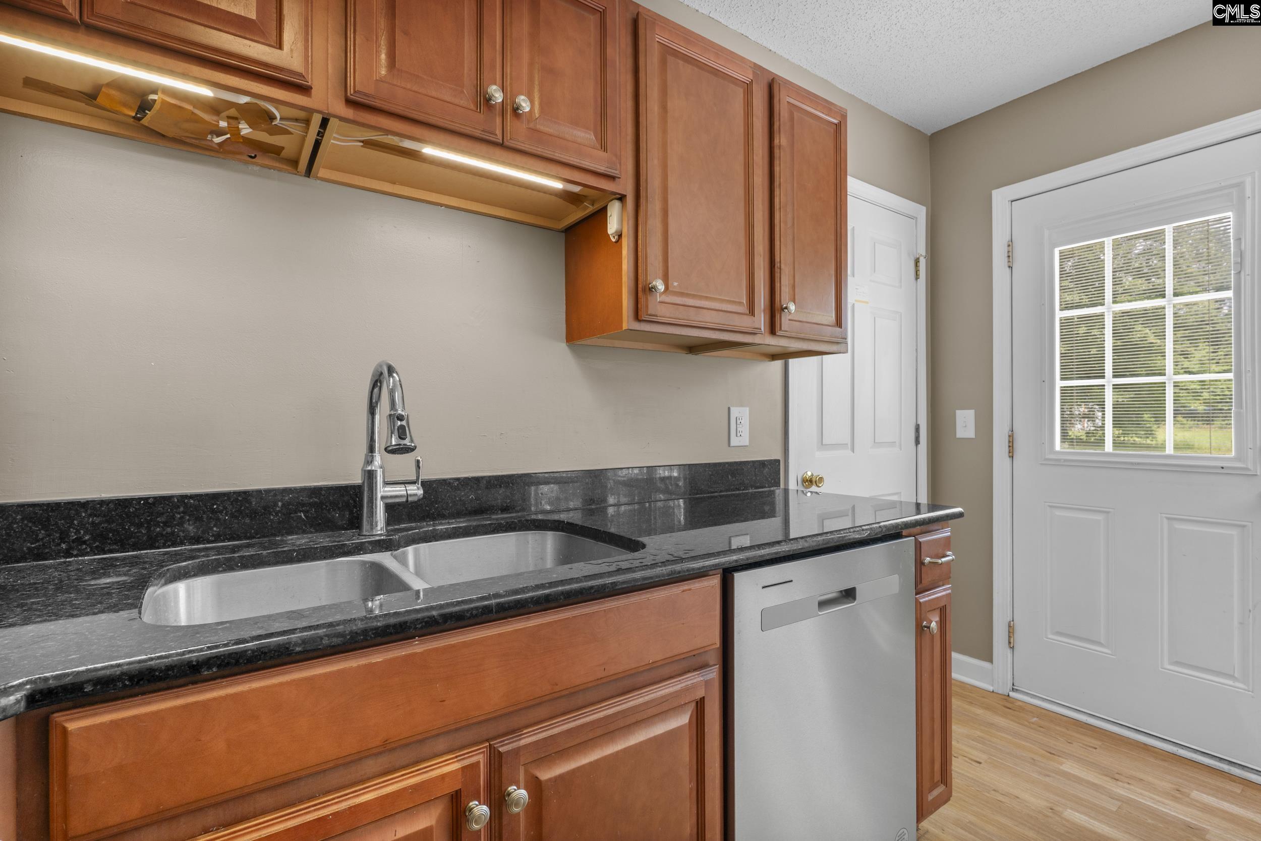 548 Eskie Dixon Road Elgin, SC 29045 - Photo 8 of 27 a kitchen with granite countertop a sink and a cabinets