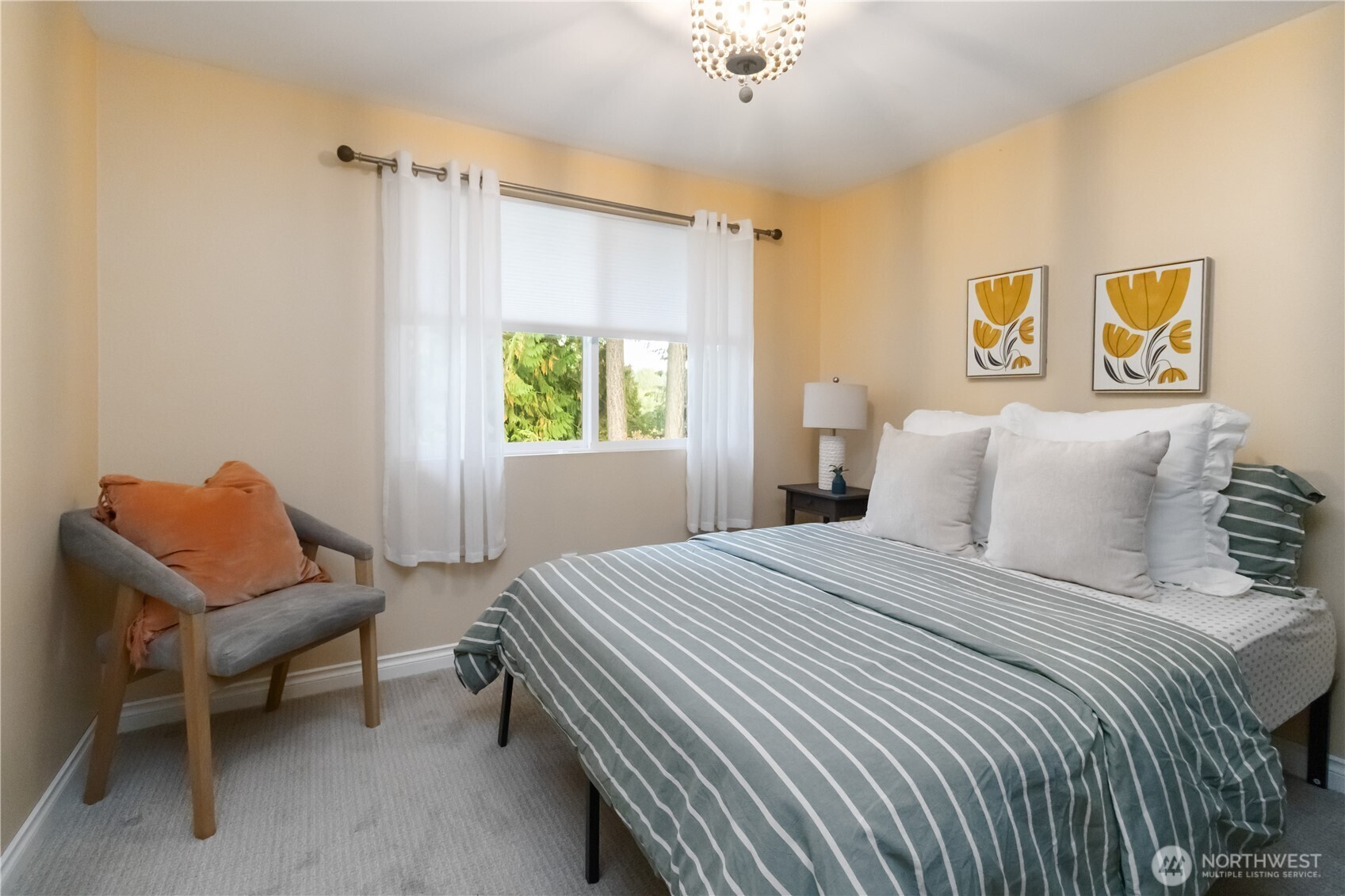 10621 Northeast 147th Street Bothell, WA 98011 - Photo 17 of 36 a bedroom with a bed and a chair