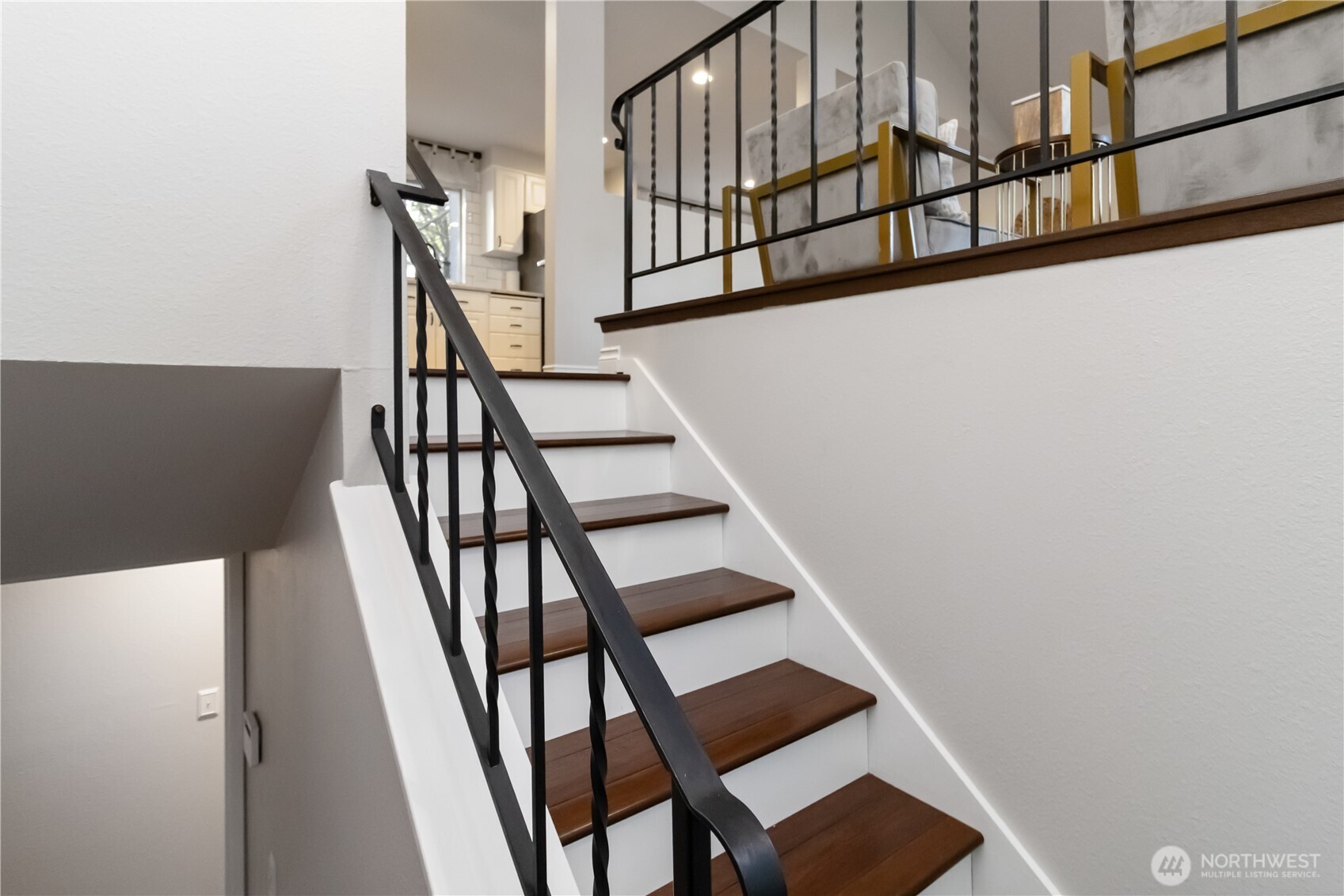 10621 Northeast 147th Street Bothell, WA 98011 - Photo 18 of 36 a view of staircase with lots of frames on wall and a window