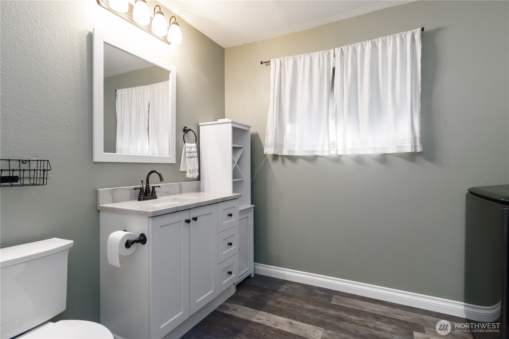 10621 Northeast 147th Street Bothell, WA 98011 - Photo 25 of 36 a bathroom with a window sink and mirror