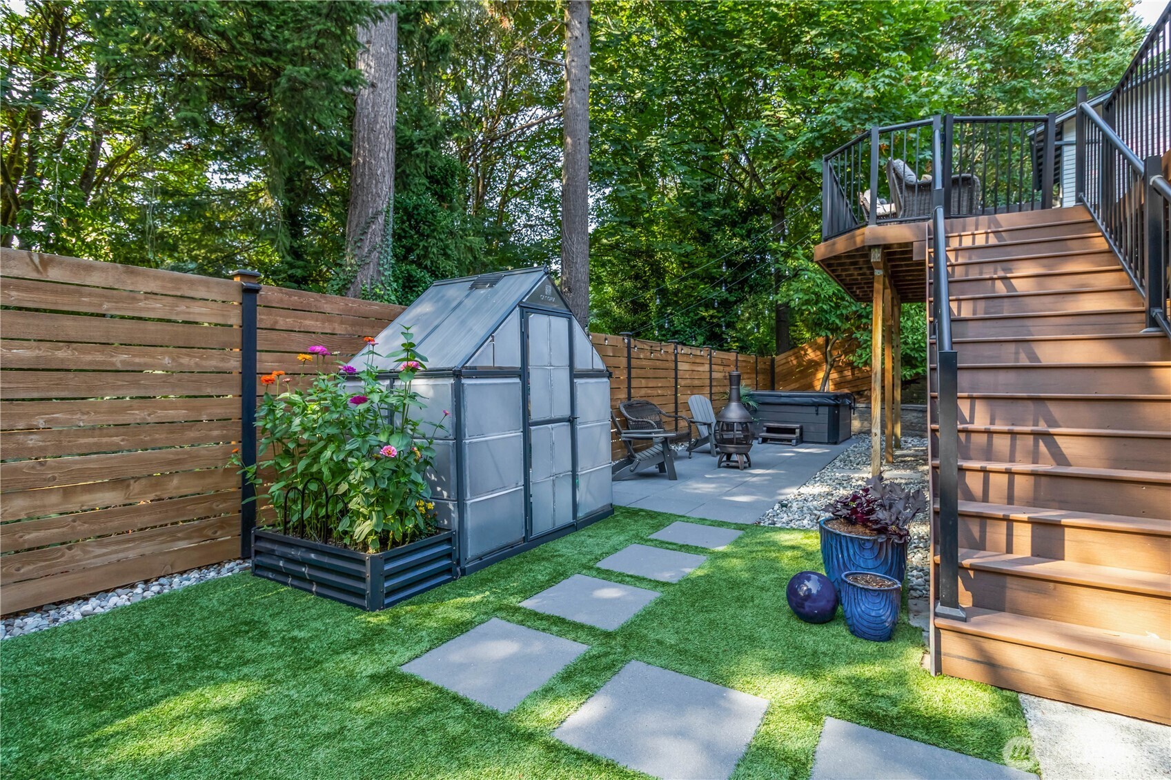 10621 Northeast 147th Street Bothell, WA 98011 - Photo 30 of 36 a view of a chair and table in backyard of the house