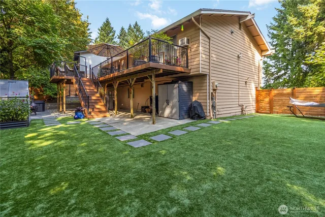 an aerial view of residential house with outdoor space and trees all around