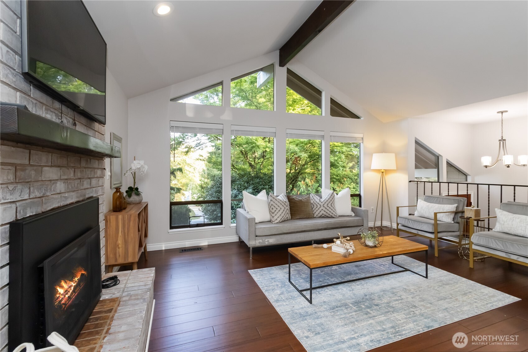 10621 Northeast 147th Street Bothell, WA 98011 - Photo 4 of 36 a living room with furniture a flat screen tv and a fireplace