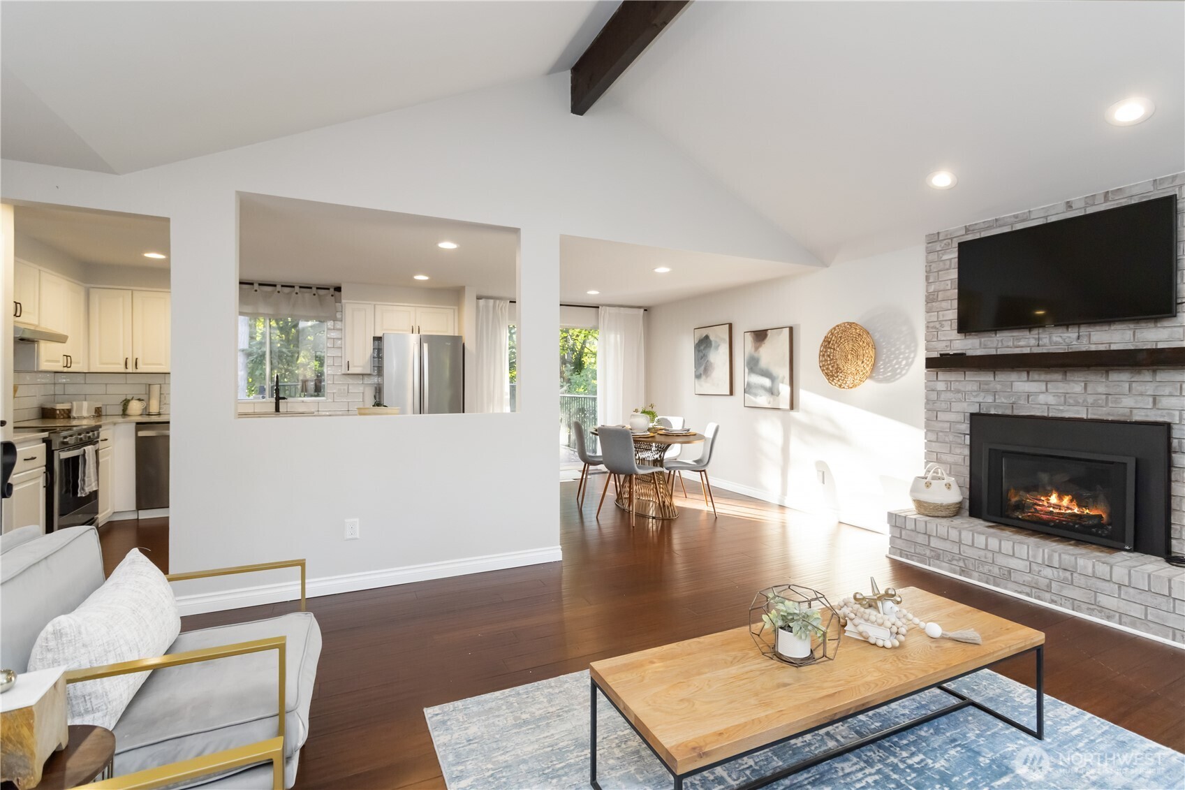 10621 Northeast 147th Street Bothell, WA 98011 - Photo 7 of 36 a living room with furniture a flat screen tv and a fireplace