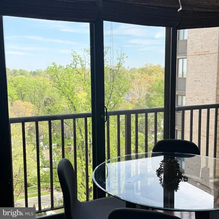 a view of a livingroom with wooden floor and a cabinet