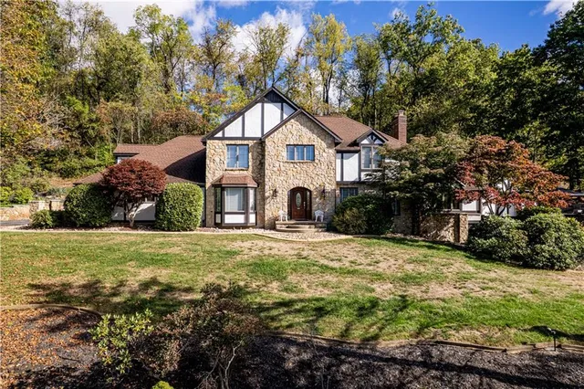 a house with a big yard and large trees