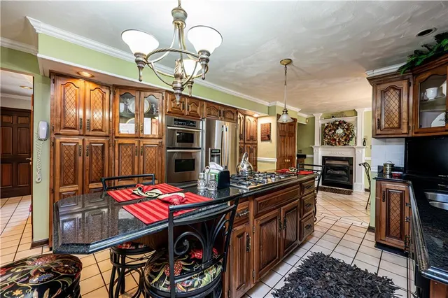 a living room with furniture flowers and a chandelier