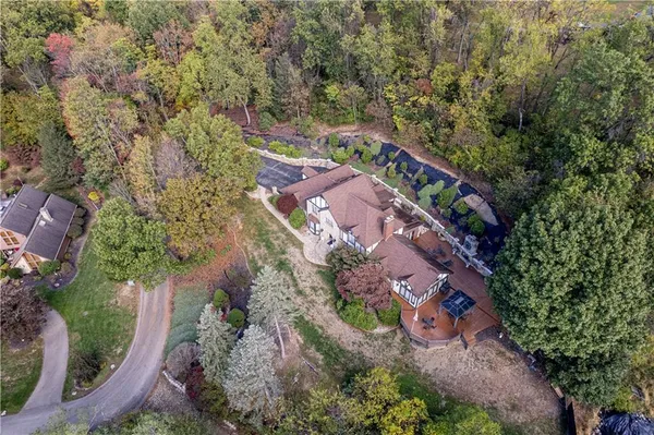 an aerial view of a house with a yard