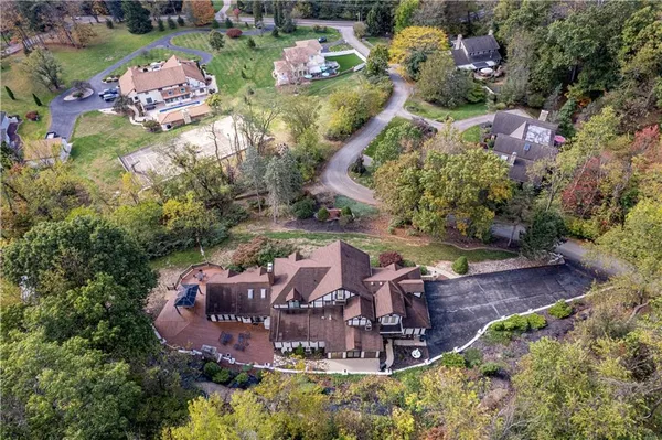 aerial view of a house with a yard and fountain