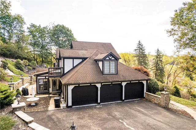 a kitchen with stainless steel appliances kitchen island granite countertop a stove refrigerator and cabinets