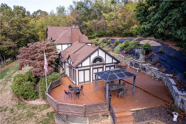 a kitchen with stainless steel appliances granite countertop a stove a sink dishwasher and a dining table with wooden floor