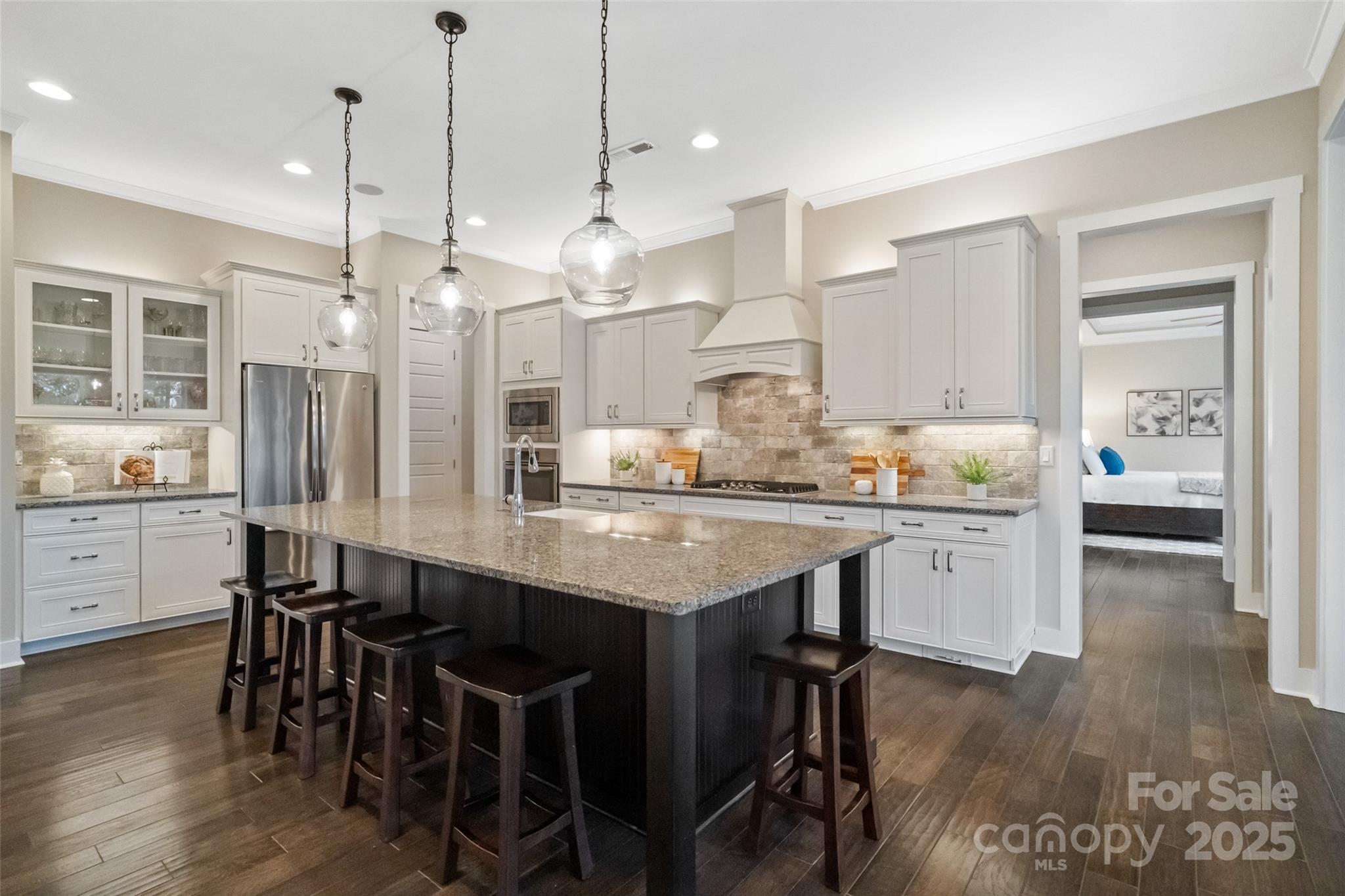 1953 Masons Bend Drive Fort Mill, SC 29708 - Photo 11 of 40 a kitchen with granite countertop a table chairs a sink dishwasher refrigerator and cabinets