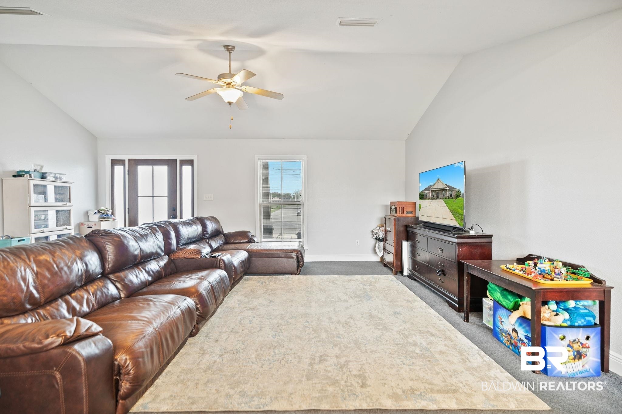 15573 Talus Court Foley, AL 36535 - Photo 10 of 50 Carpeted living room featuring ceiling fan and vaulted ceiling