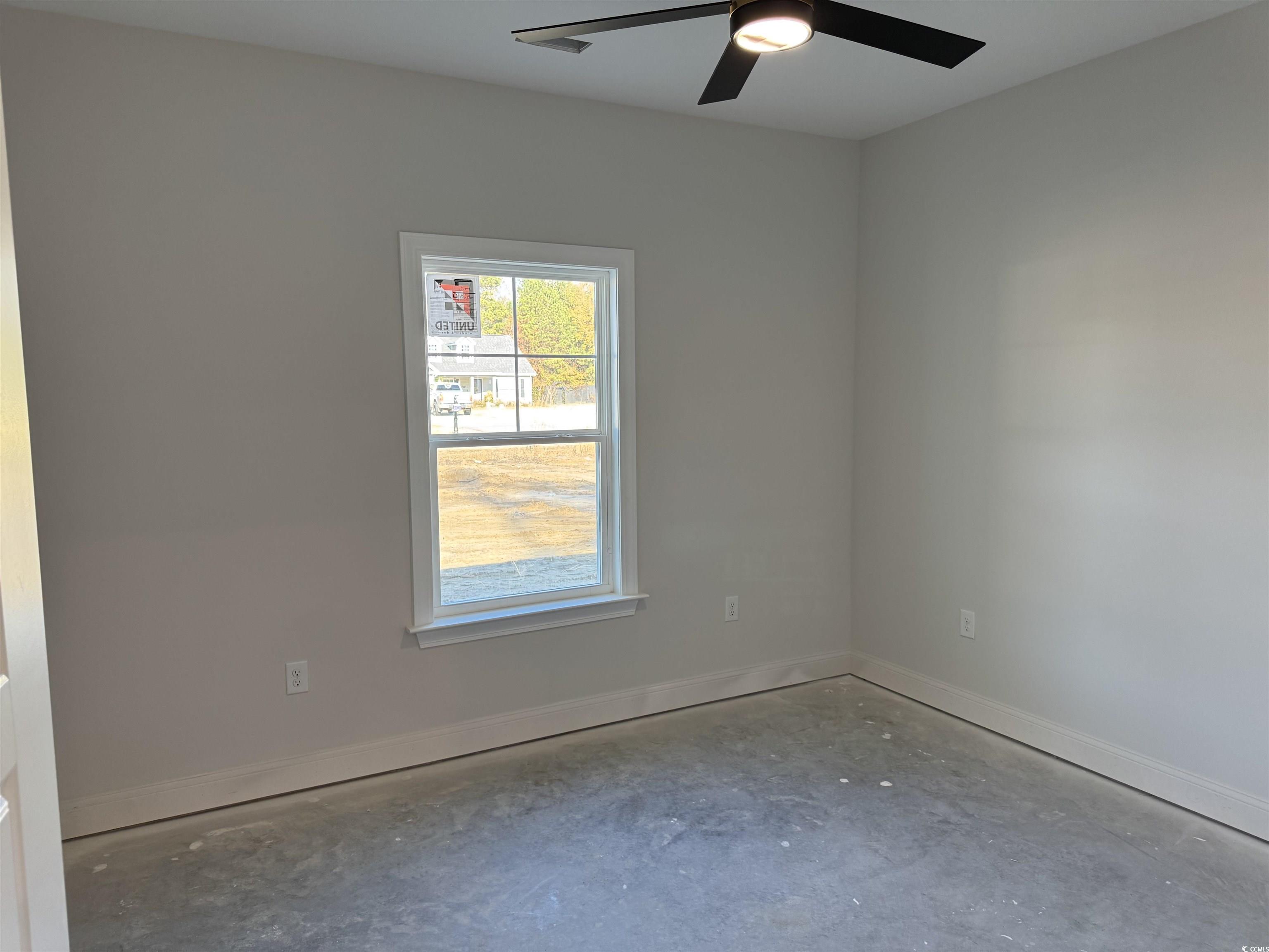 409 St John Road Galivants Ferry, SC 29544 - Photo 12 of 17 Empty room with unfinished concrete flooring and a ceiling fan