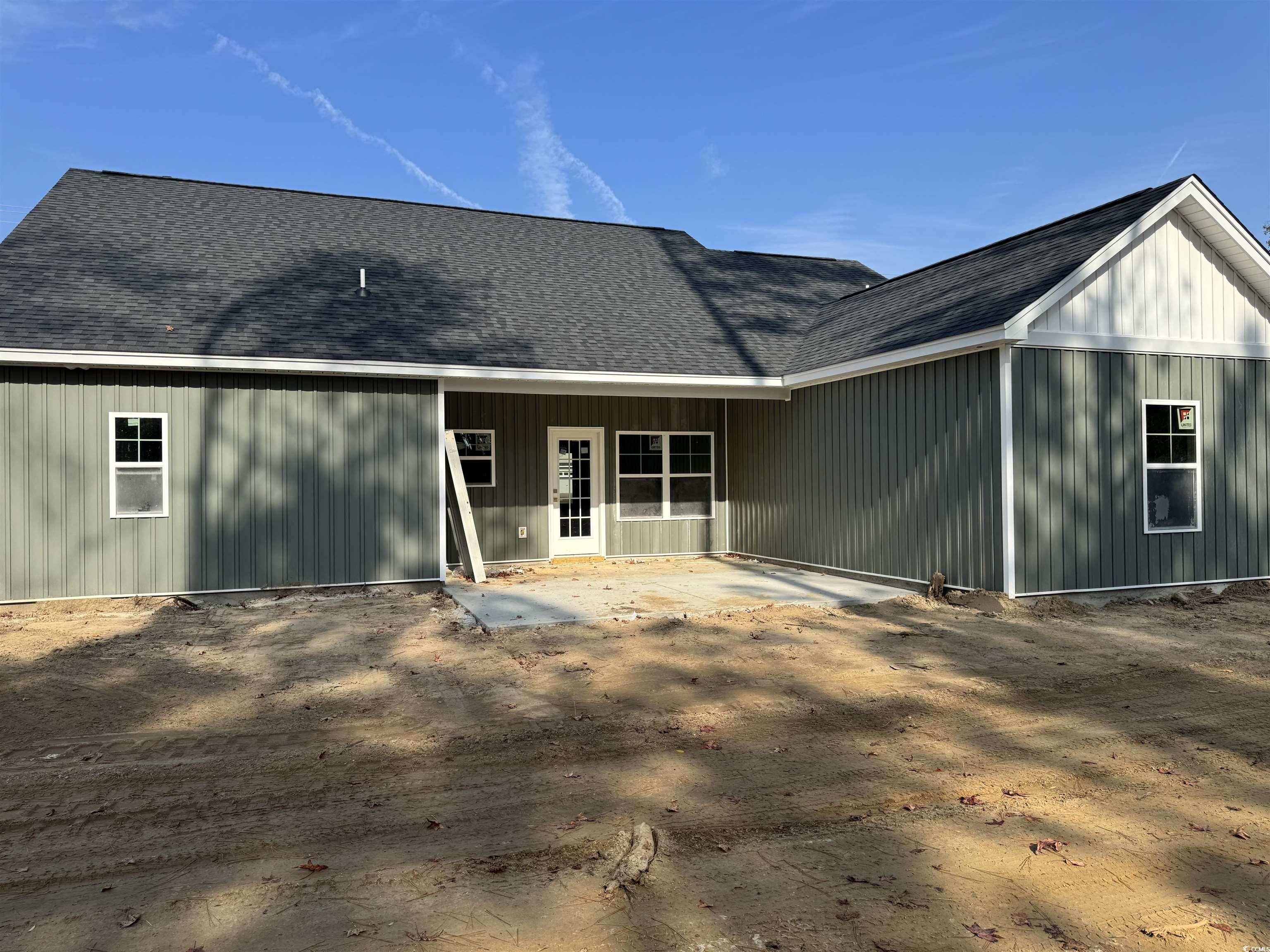 409 St John Road Galivants Ferry, SC 29544 - Photo 16 of 17 Back of property with roof with shingles and a patio area