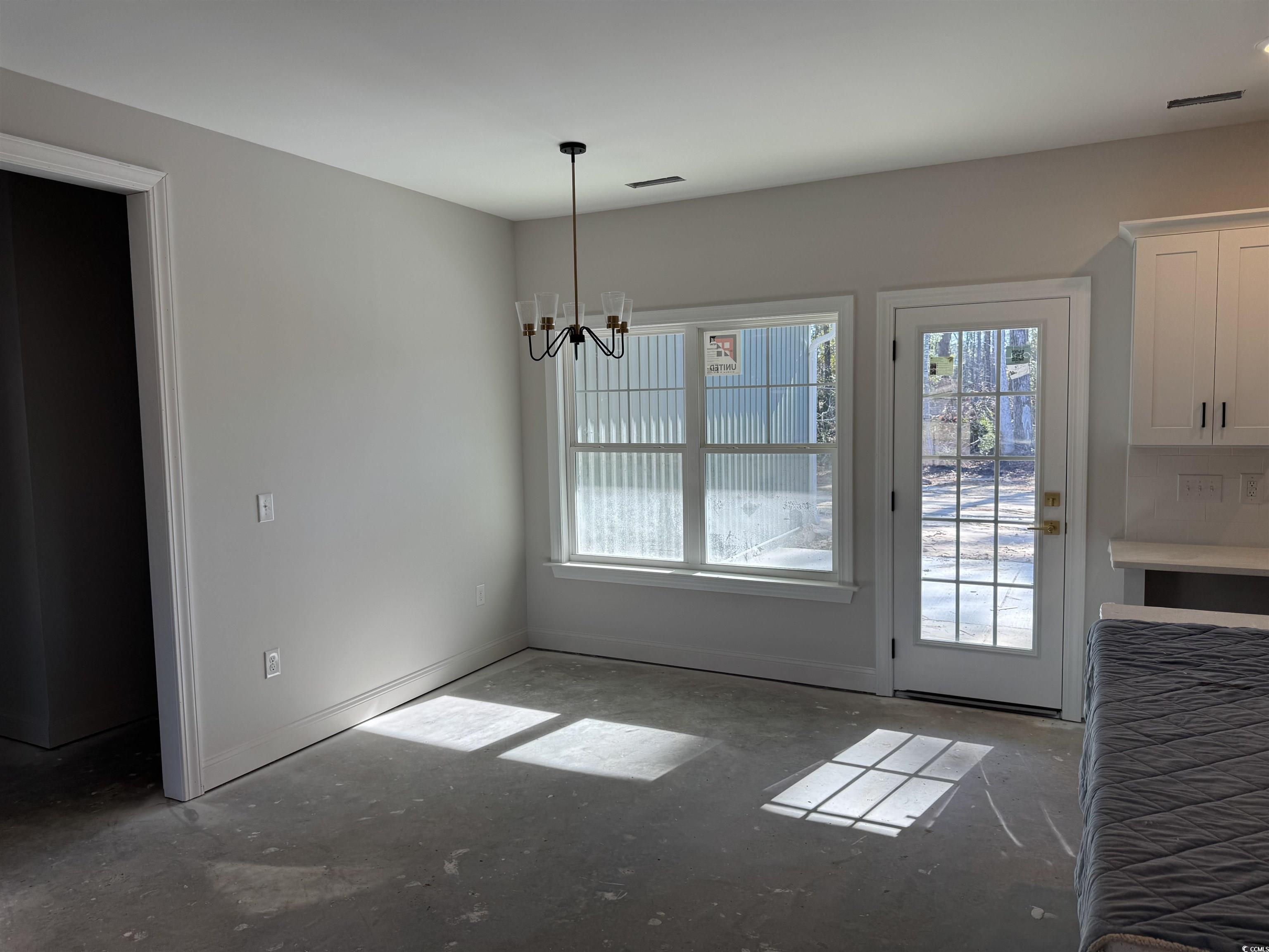 409 St John Road Galivants Ferry, SC 29544 - Photo 8 of 17 Unfurnished dining area with a chandelier and concrete floors