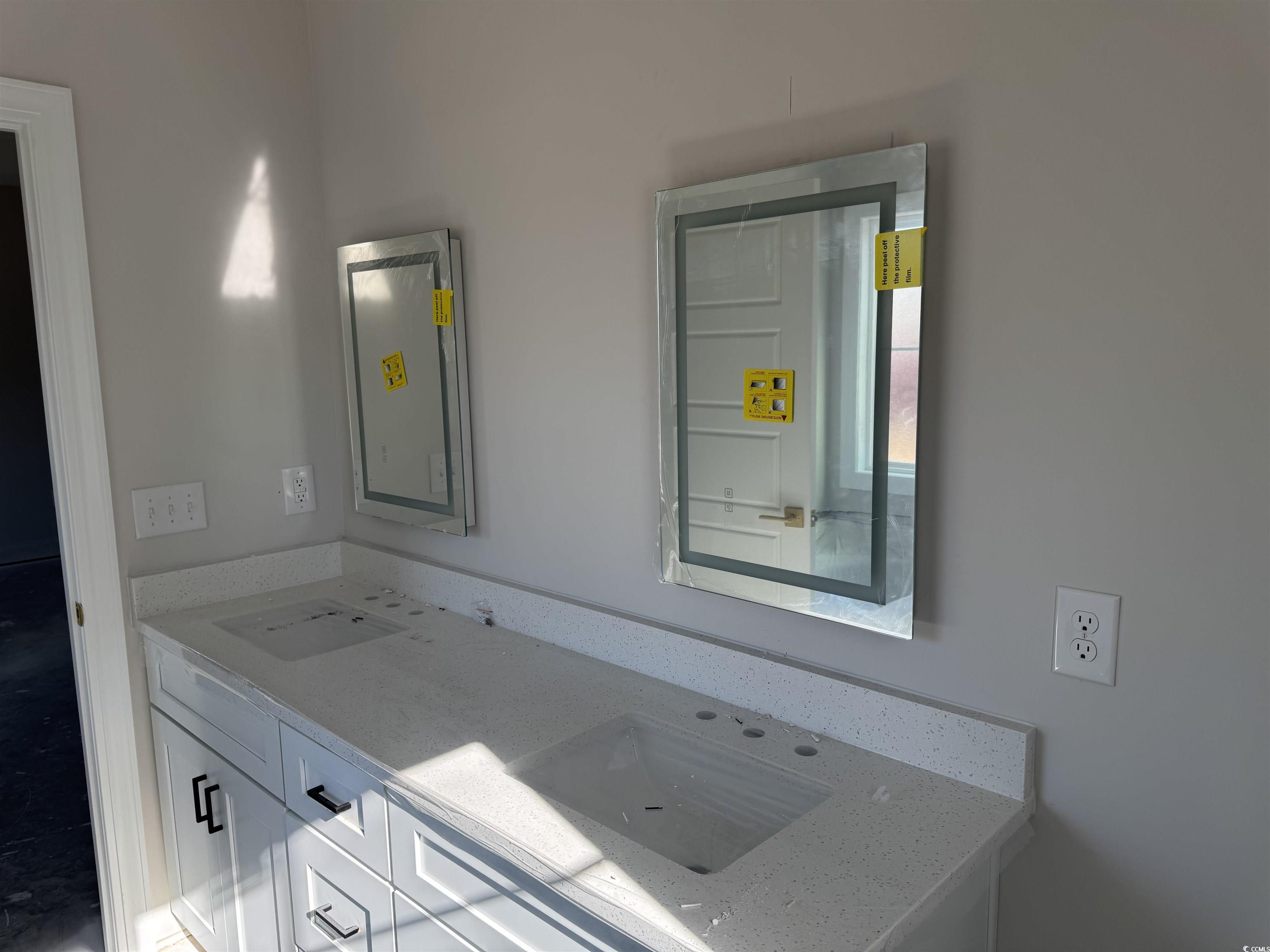 409 St John Road Aynor, SC 29544 - Photo 9 of 16 Empty room featuring unfinished concrete floors, ceiling fan, ornamental molding, and a tray ceiling