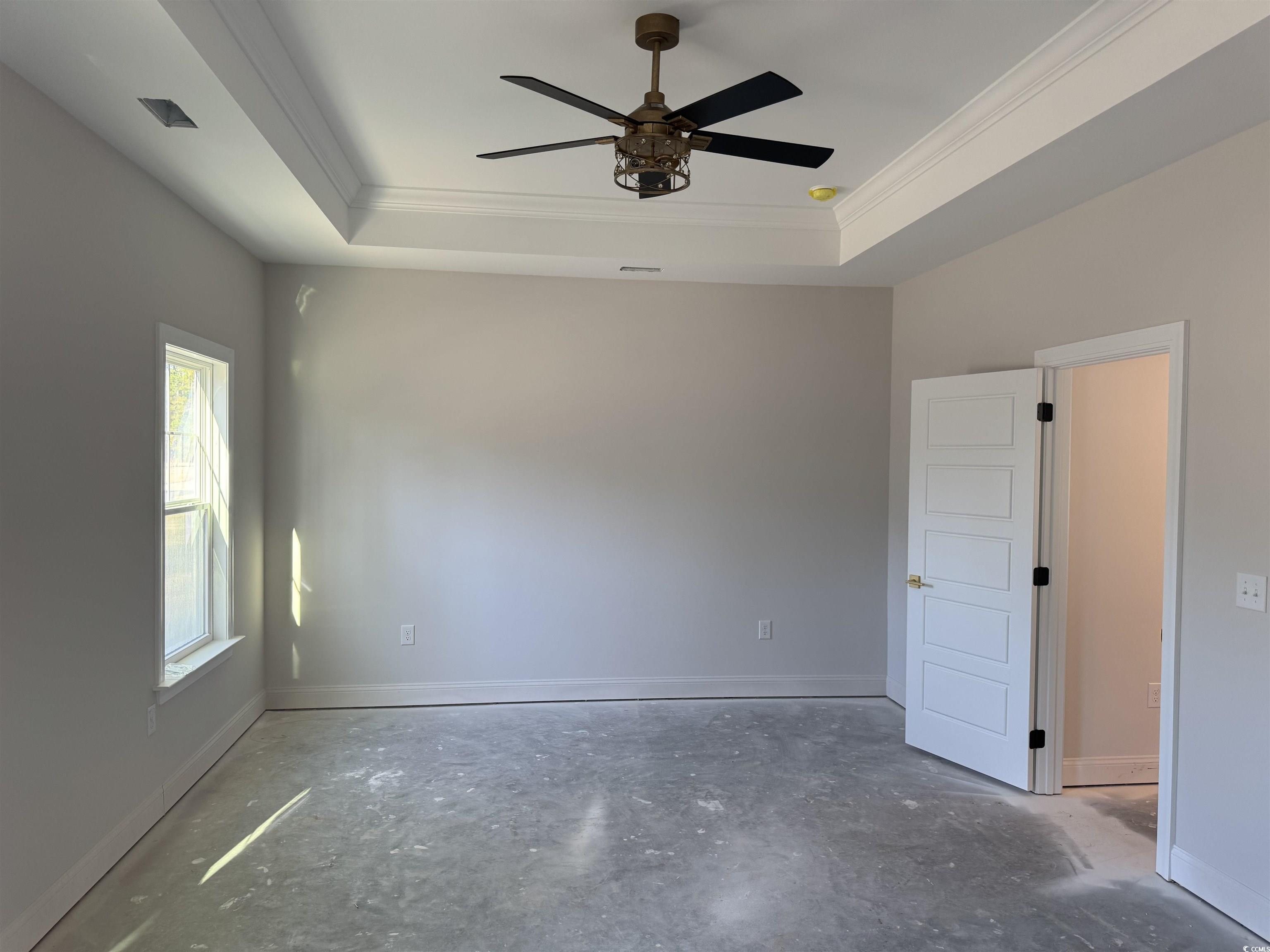 409 St John Road Galivants Ferry, SC 29544 - Photo 9 of 17 Empty room featuring unfinished concrete floors, ceiling fan, ornamental molding, and a tray ceiling