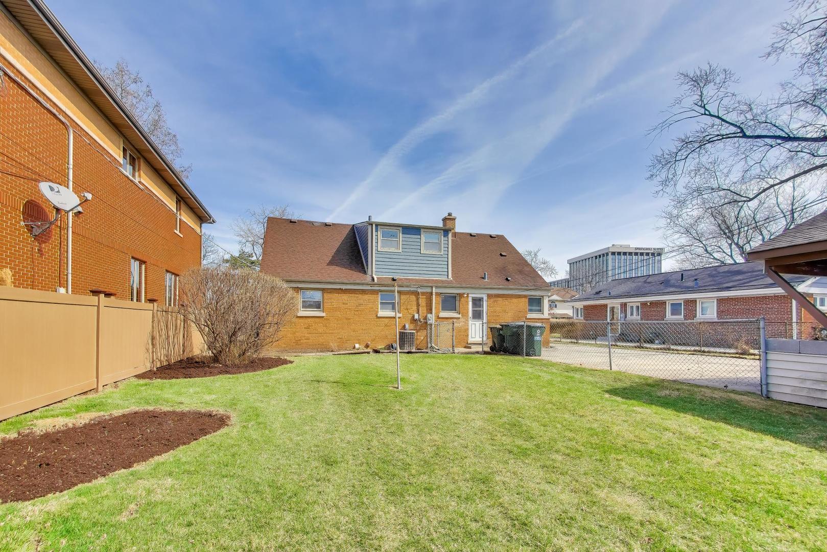 1916 Courtland Avenue Park Ridge, IL 60068 - Photo 27 of 31 a view of a house with a big yard and large trees