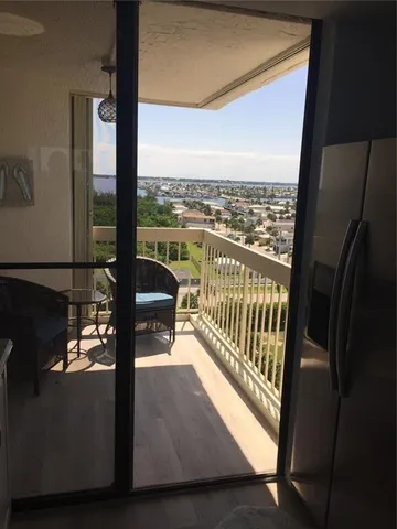 a view of a glass door with a chair