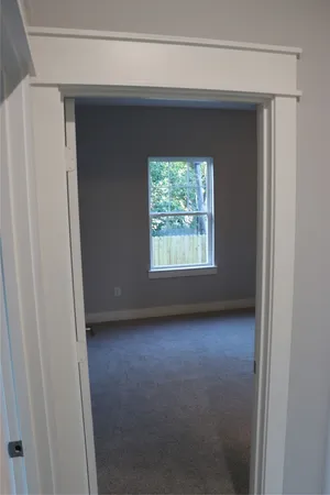 a view of an empty room and a window