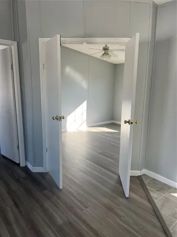 an empty room with wooden floor and closet