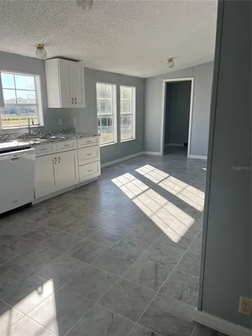 a view of a kitchen with windows