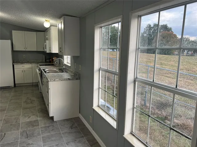 a kitchen with a white cabinets and a sink