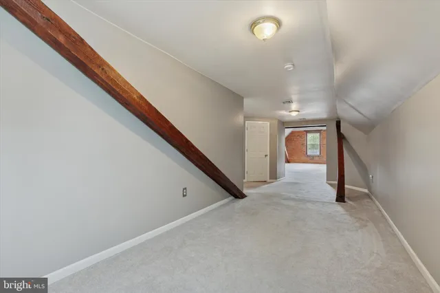 a view of a hallway with white walls