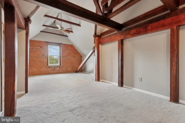 a spacious bedroom with a bed and a walk in closet