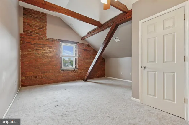 a view of staircase with railing and white walls