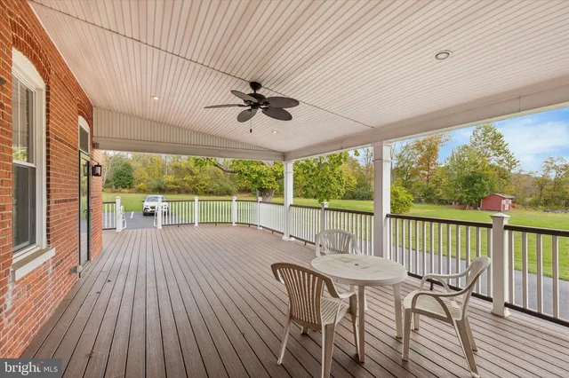 a view of a balcony with furniture and wooden floor