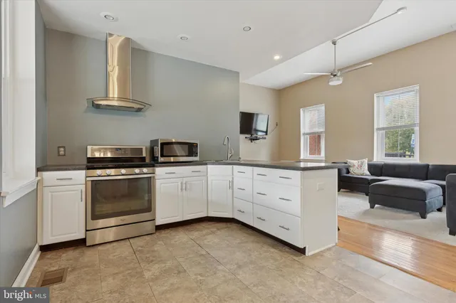 a kitchen with white cabinets and white appliances