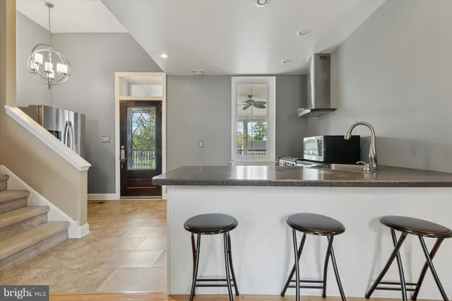 a kitchen with lots of counter space and chairs