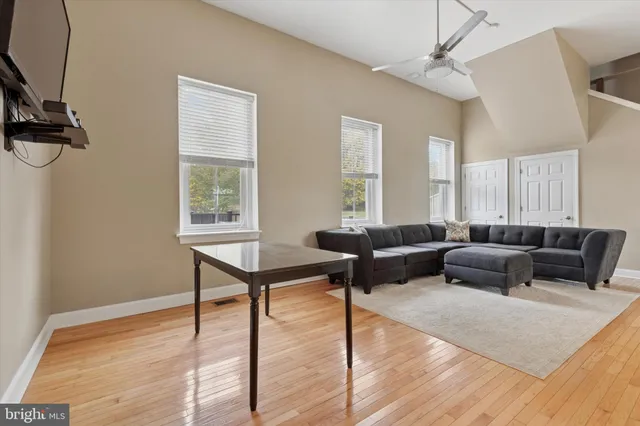 a living room with furniture and a wooden floor