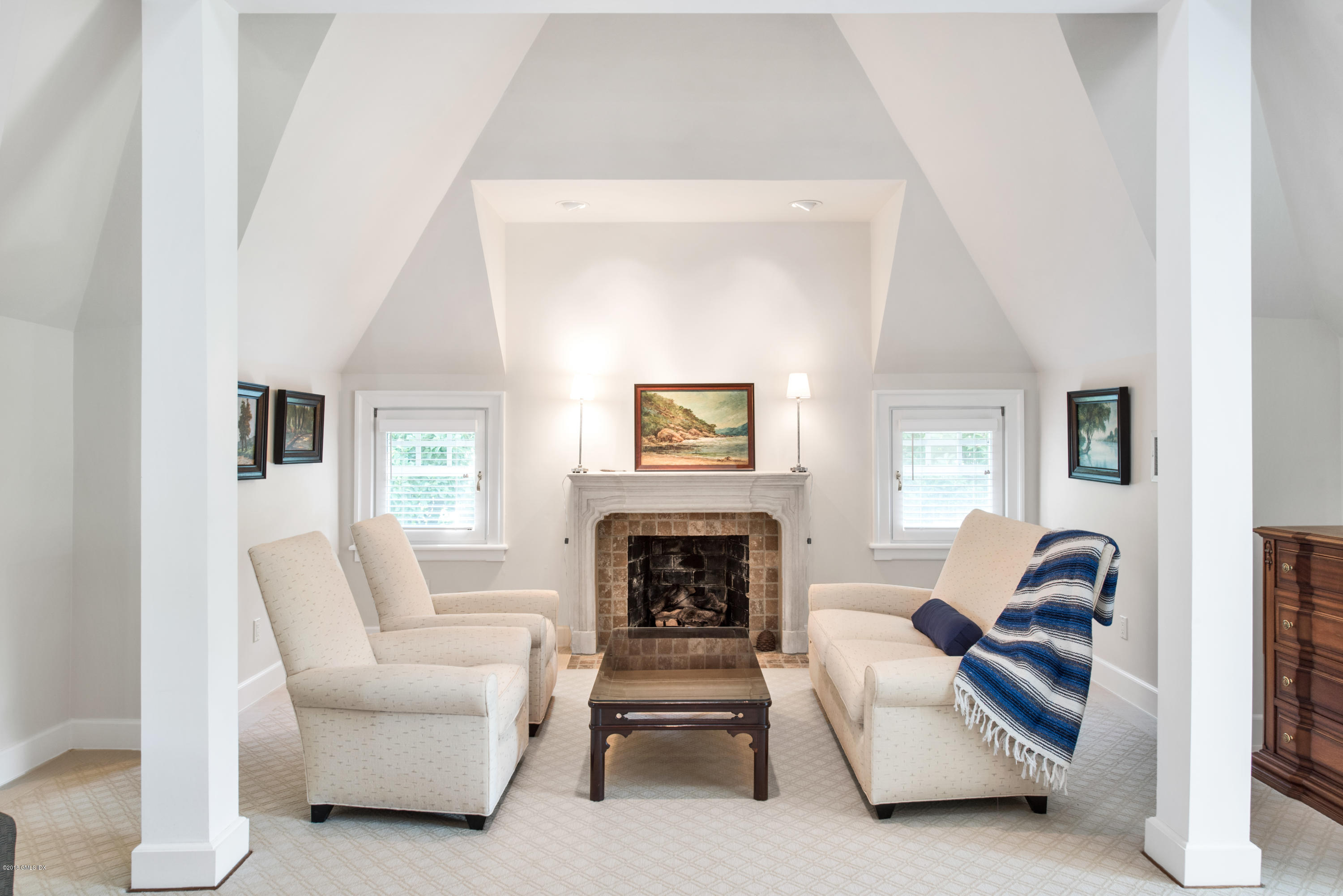 147 Byram Shore Road Greenwich, CT 06830 - Photo 11 of 19 a living room with furniture and a fireplace