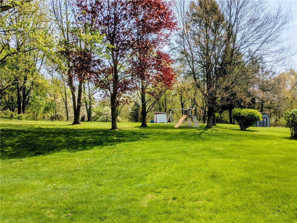JUST SHY OF 1 ACRE, PLAYSET AND SHED INCLUDED.