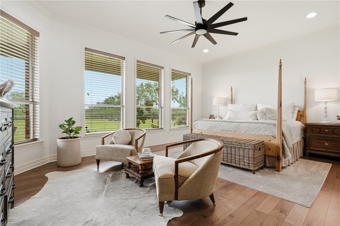 8710 KIng Ranch Drive Corpus Christi, TX 78414 - Photo 16 of 38 a spacious bedroom with a bed a couch and a large window