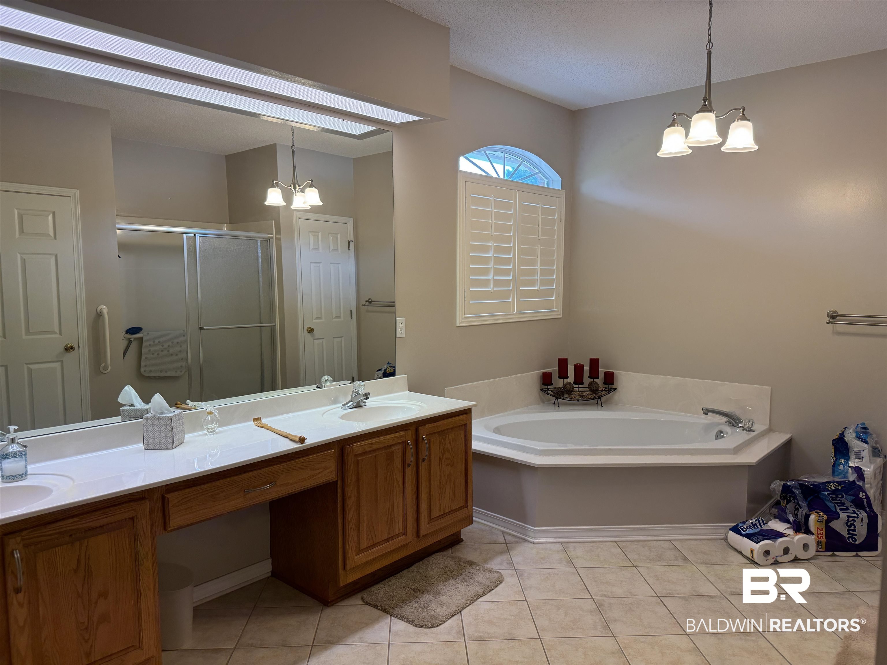 9139 Clubhouse Drive Foley, AL 36535 - Photo 22 of 30 Bathroom with dual vanity, independent shower and bath, a chandelier, and tile patterned floors