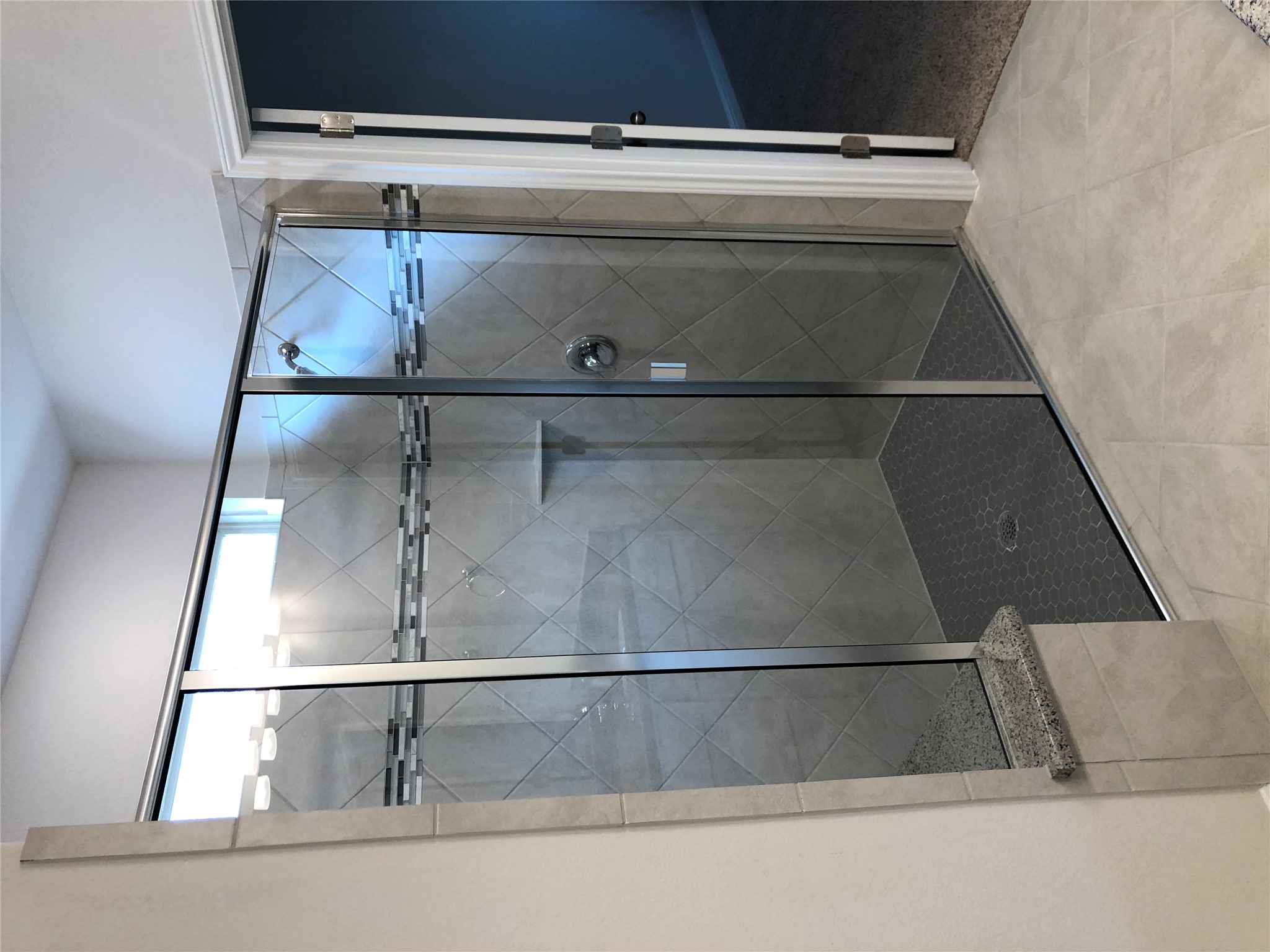 2746 Fortezza Way Round Rock, TX 78665 - Photo 11 of 16 Gleaming glass surrounds a spacious walk-in shower lined with detailed tile accents.