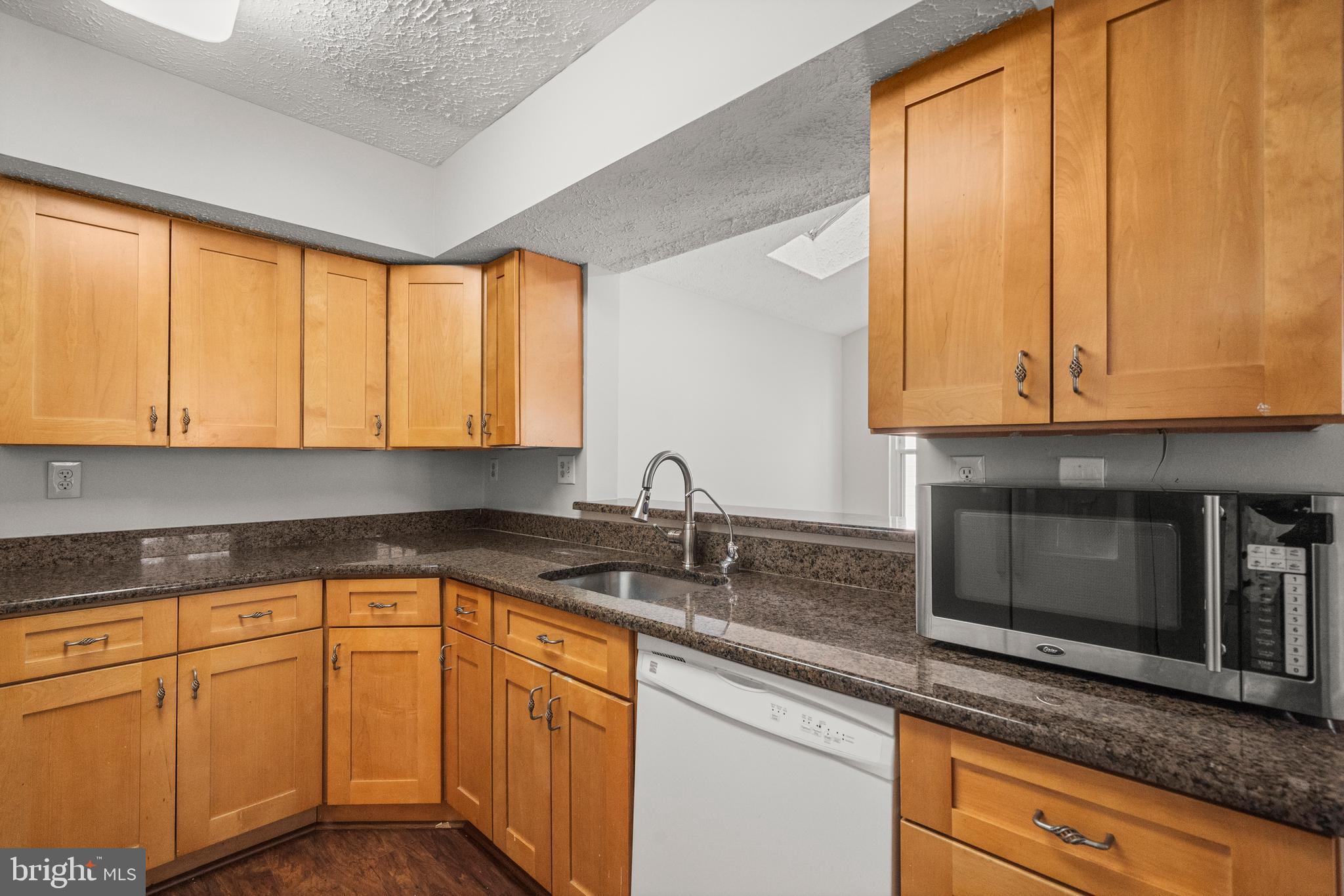 4001 Bittern Court Waldorf, MD 20603 - Photo 17 of 53 a kitchen with stainless steel appliances granite countertop white cabinets sink and a granite counter top