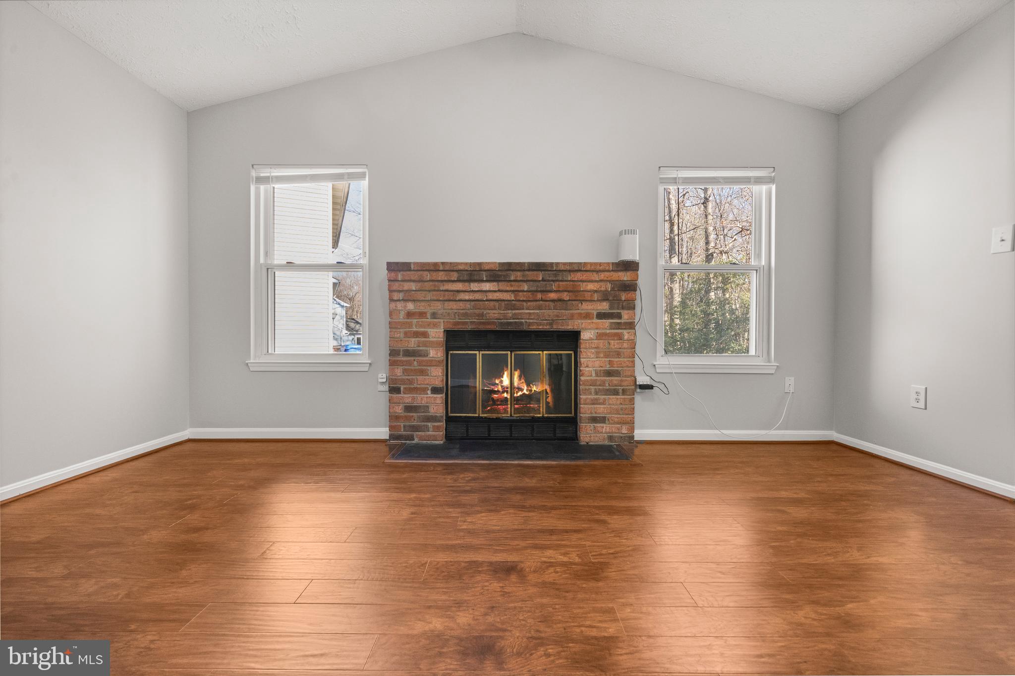 4001 Bittern Court Waldorf, MD 20603 - Photo 22 of 53 a view of an empty room with wooden floor fireplace and a window
