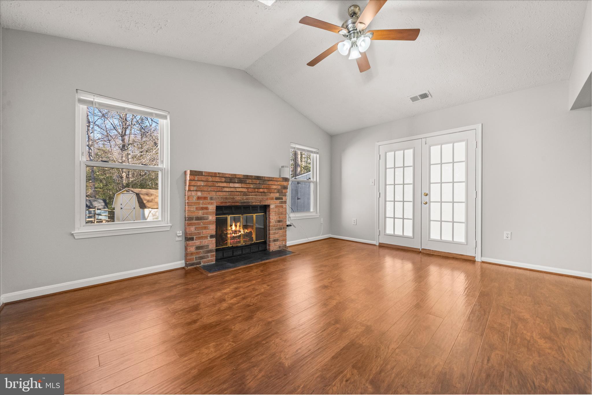 4001 Bittern Court Waldorf, MD 20603 - Photo 24 of 53 a view of empty room with wooden floor fireplace and fan