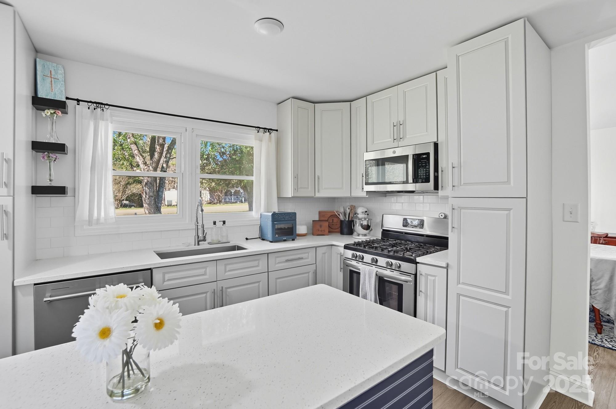 813 Bethlehem Road Kings Mountain, NC 28086 - Photo 11 of 39 a kitchen with a stove a sink and a microwave